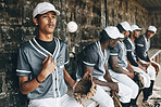 Baseball, sports and team with a man athlete thinking about the match or game while sitting in the dugout. Exercise, fitness and idea with a male baseball player group ready to play in a match