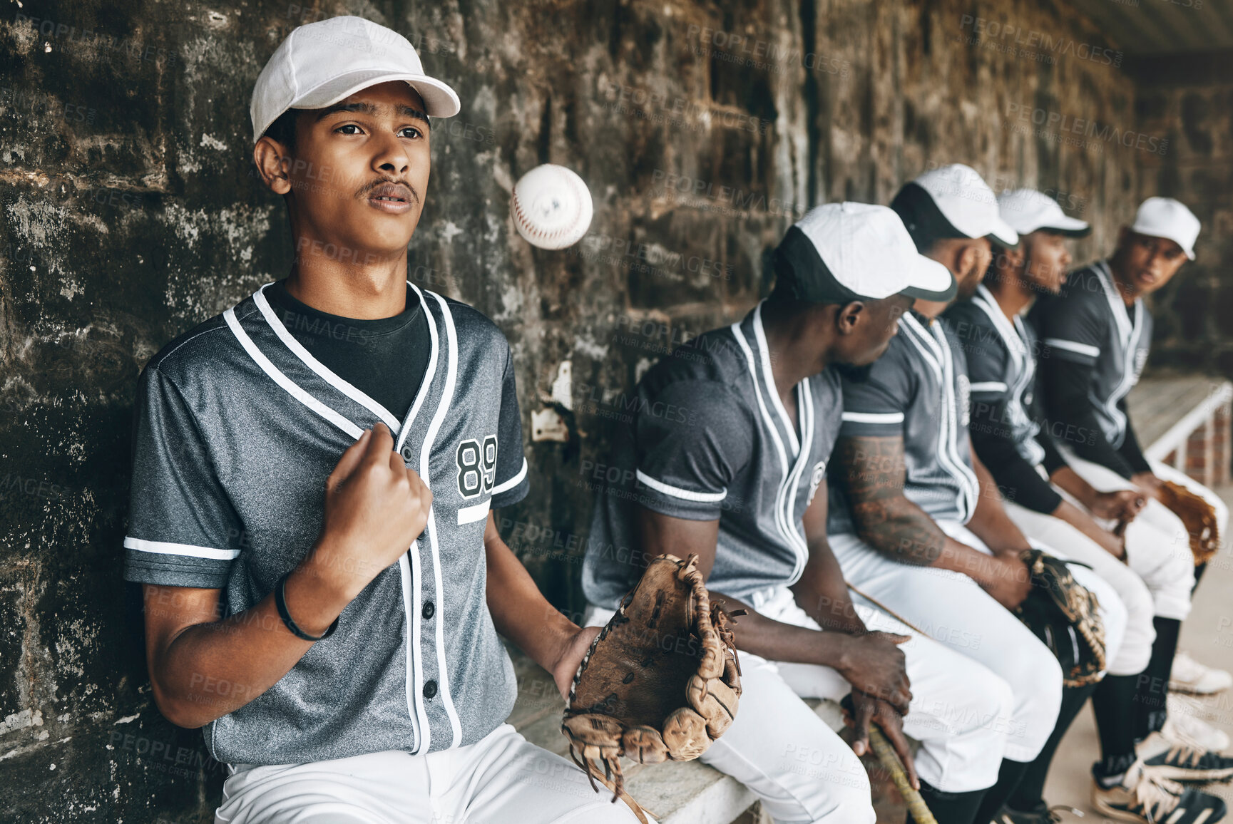 Buy stock photo Baseball, sports and team with a man athlete thinking about the match or game while sitting in the dugout. Exercise, fitness and idea with a male baseball player group ready to play in a match