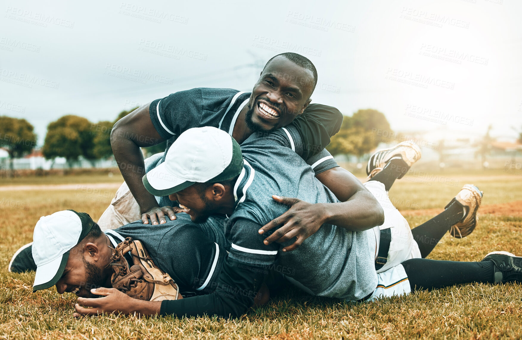 Buy stock photo Winner, team and baseball player success celebration on baseball field by men celebrating on the ground after winning a game. Sports victory, softball and happy group dive on grass at softball field