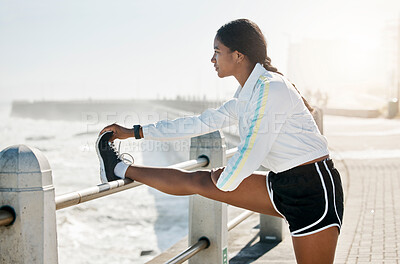 Buy stock photo Stretching legs, fitness and woman training in nature for motivation in morning, health and outdoor run. Strong, thinking and young athlete runner doing warm up before running by the ocean for cardio