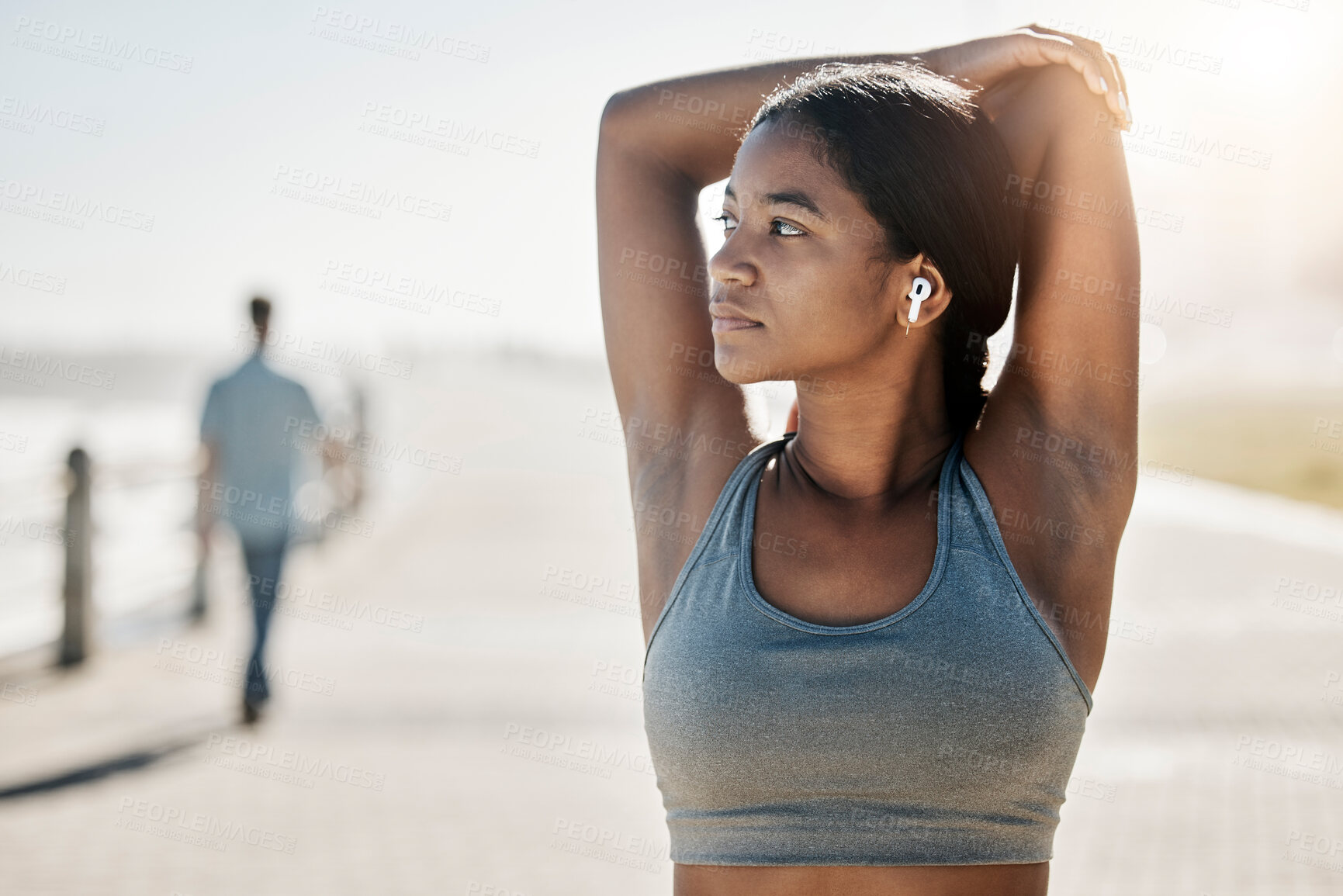 Buy stock photo Stretching, earphones and running with black woman training at beach side for health, fitness or sports workout. Exercise, peace and summer with girl runner and warm up with music, podcast or energy