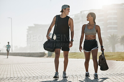 Sports, personal trainer and woman in fitness walking with a soccer ball for cardio exercise, workout and training session. Smile, wellness and happy couple enjoy a healthy city lifestyle in summer