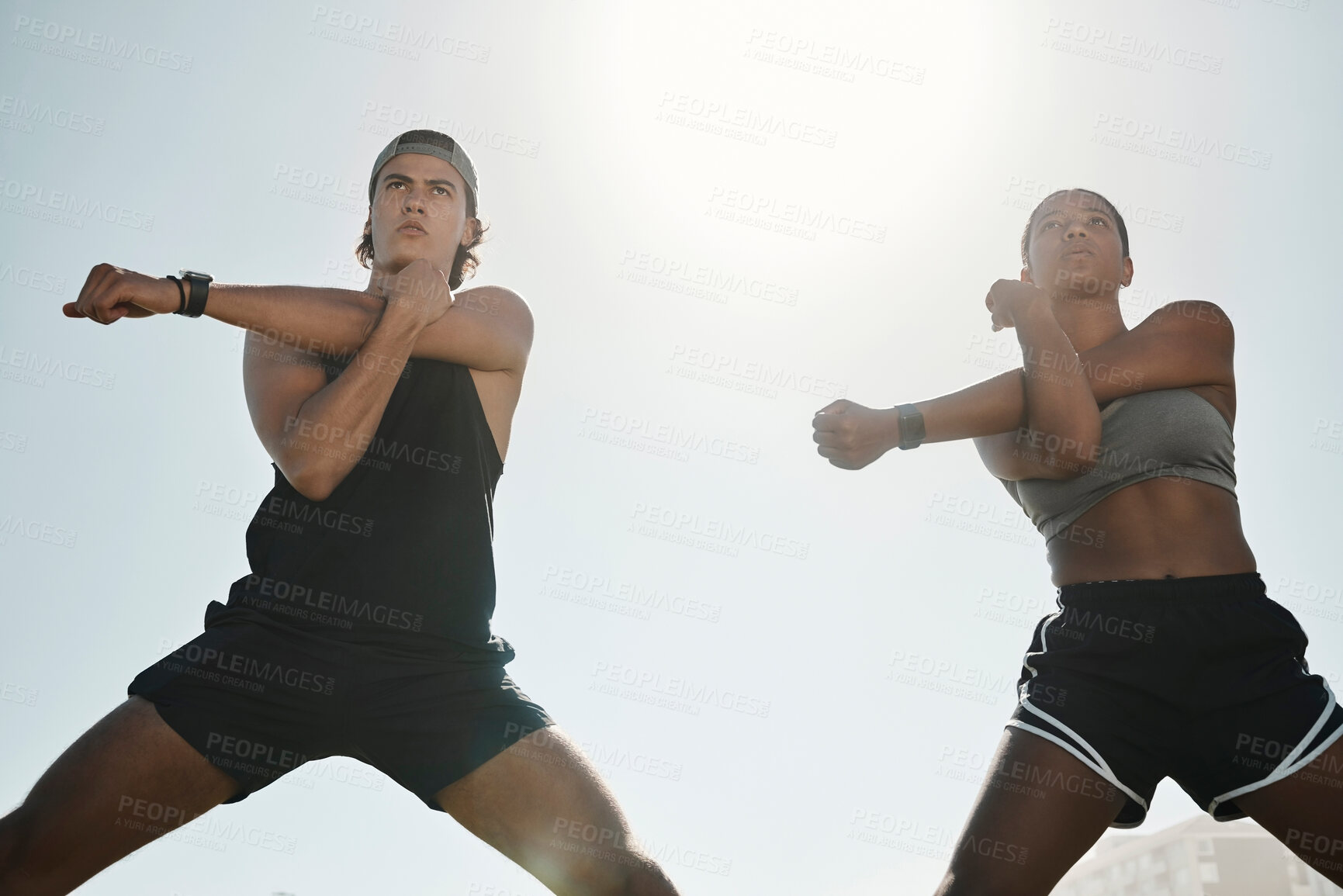 Buy stock photo Blue sky, fitness and stretching couple outdoor ready for workout, training or run. Health, diversity or man, woman and body warm up for running, exercise or sports for wellness in sunshine low angle