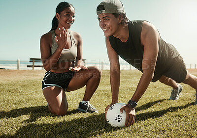 Soccer, sports and coach with a man athlete training outside for fitness or exercise with his personal trainer. Football, workout and health with a male listening to coaching on a field of grass