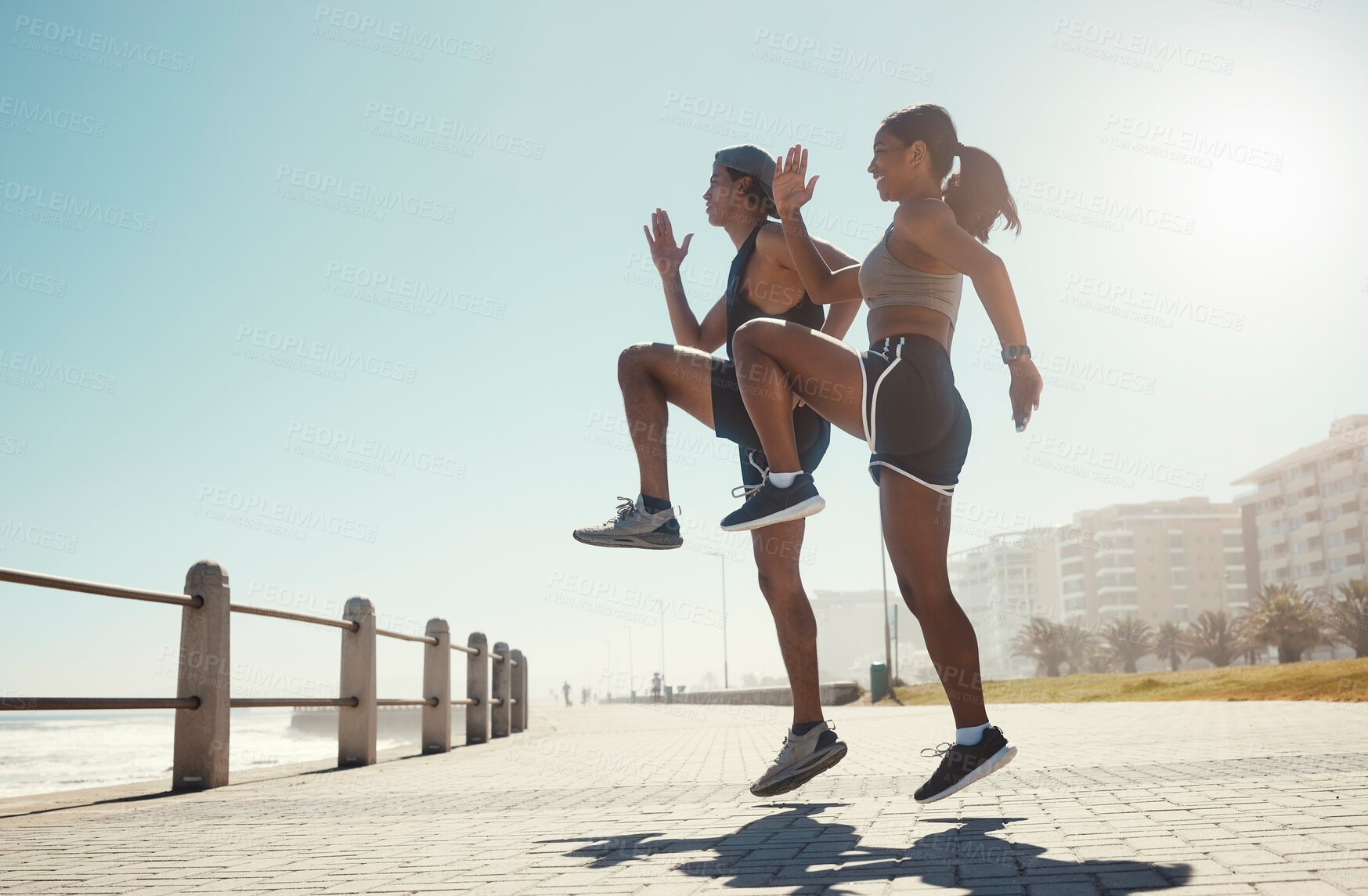 Buy stock photo Fitness, nature and couple exercise in beach park, jump wellness and outdoor cardio workout on promenade. Motivation, health and sport partnership or friends in sports training or active lifestyle
