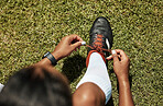 Shoes tie, sports and soccer black woman athlete on green grass ready for exercise and training. Fitness, workout and game of a healthy person player before football cardio in nature and summer