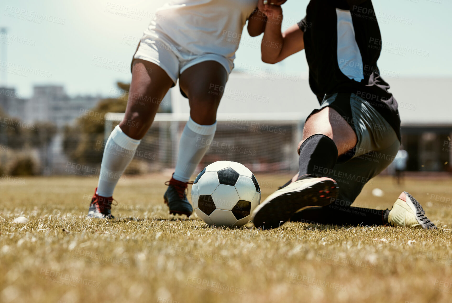 Buy stock photo Soccer, sports and athletes playing with a ball on an outdoor field for a match or training. Fitness, men and closeup of football players legs running with skill on a pitch for a game or exercise.