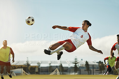 Soccer, game and man kicking a ball during training with the team on a field for sports. Athlete football player in the air to jump for a goal while playing in a professional match or competition