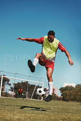 Buy stock photo Sport, fitness and soccer training with soccer player in soccer ball power kick on a soccer field, energy, exercise and passion. Sports, football and football player ball practice on football field