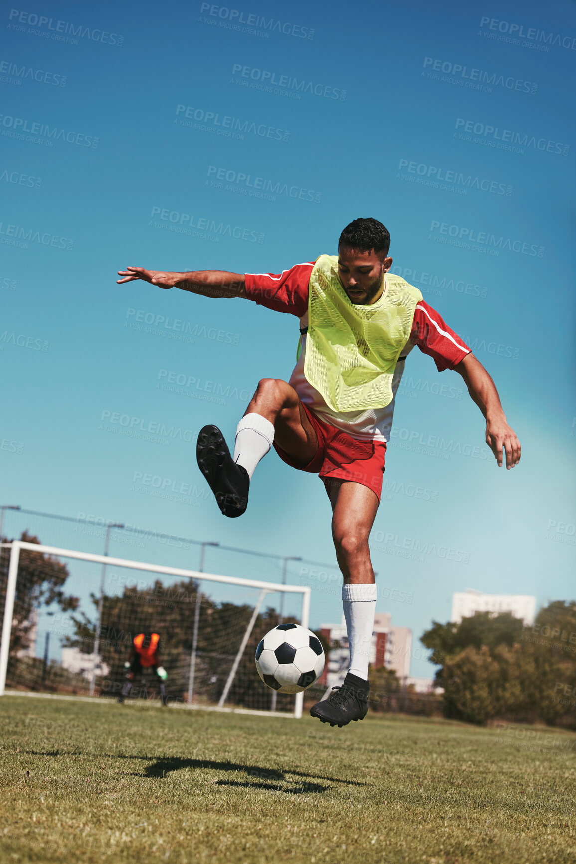 Buy stock photo Sport, fitness and soccer training with soccer player in soccer ball power kick on a soccer field, energy, exercise and passion. Sports, football and football player ball practice on football field