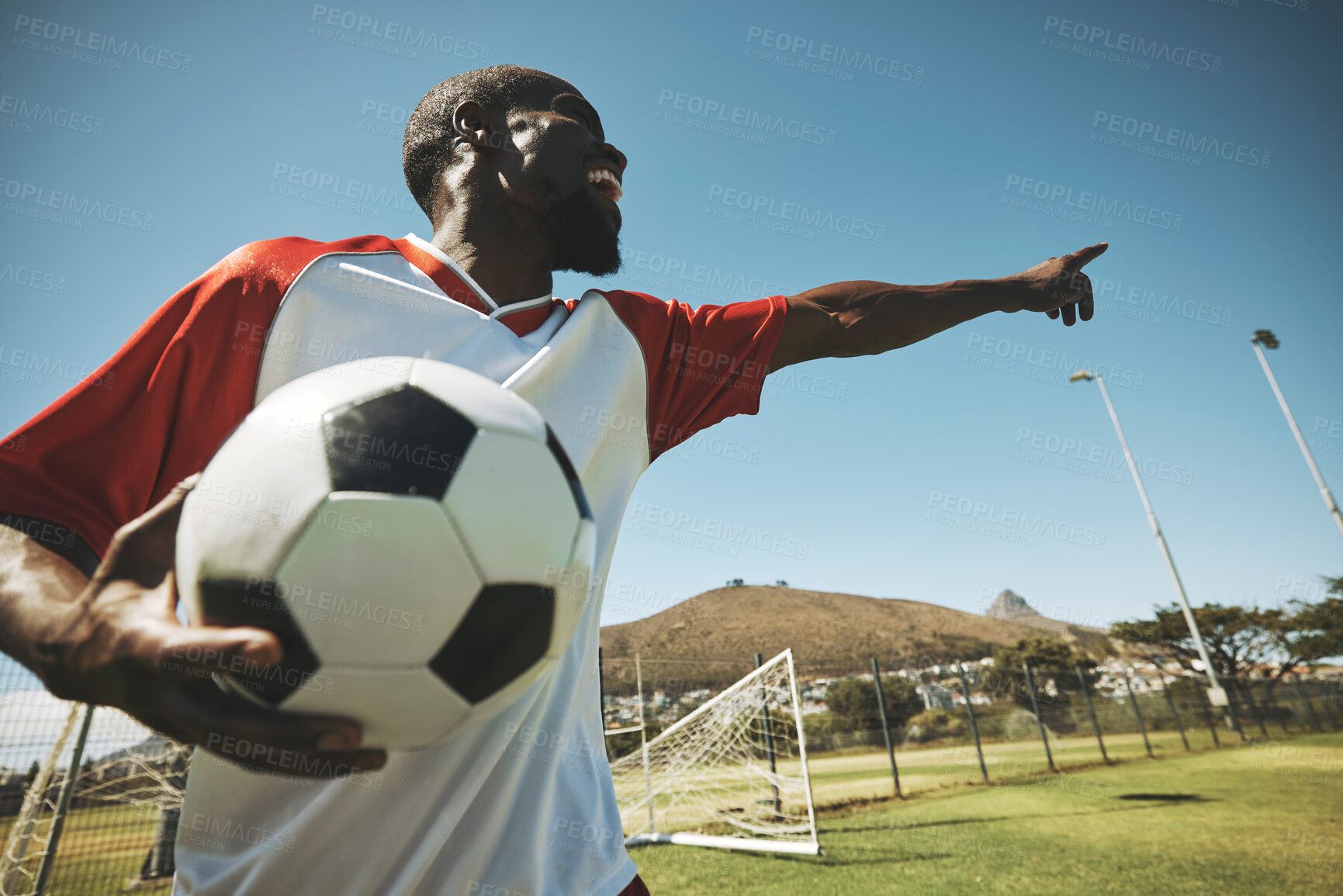 Buy stock photo Soccer, football player and black man on a sports field with ball for game or match. Fitness, happy captain male and cardio training of an athlete outdoor for exercise with energy and motivation