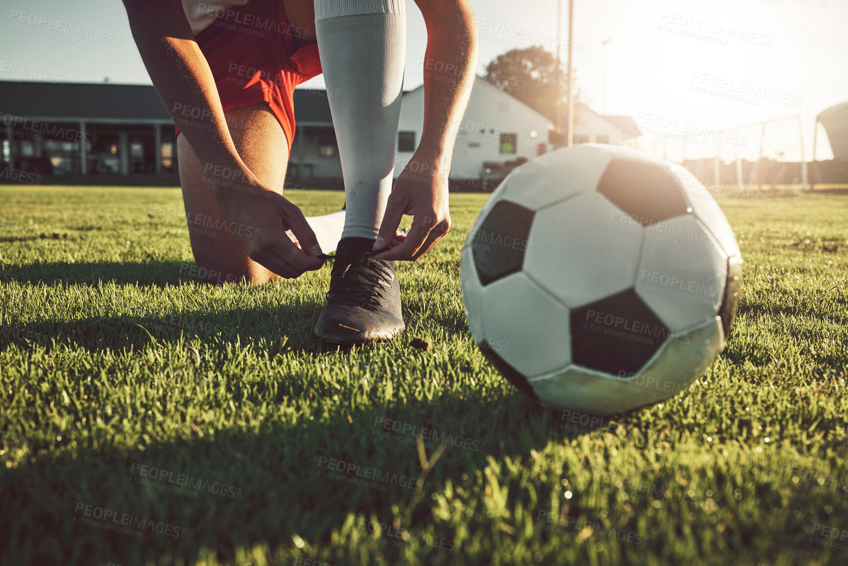 Buy stock photo Fitness, shoes and soccer player ready for sports training, exercise and cardio workout on football field outdoors. Hands, footwear and athlete tying boots to start a practice game or match 