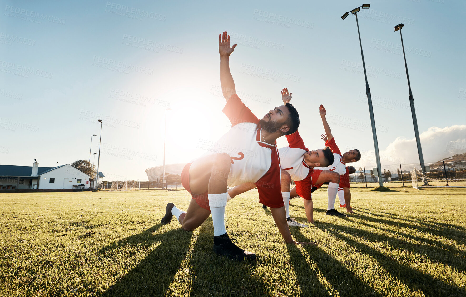 Buy stock photo Soccer, football player and team stretching for sports match, training and practice of athlete men before game on outdoor field. Exercise, fitness and workout with male group ready for sport on grass