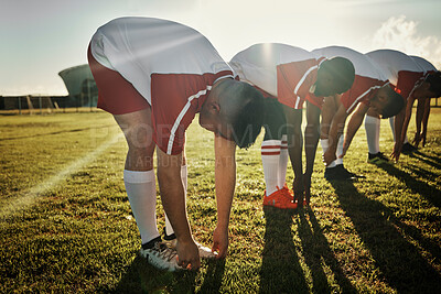 Buy stock photo Team, stretching and legs in soccer training, warm up or exercise on field in sunshine at game. Man, football and group together for workout, teamwork and fitness before match, competition or sports