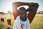 Football player, soccer and stretching black man doing sports training on field for warm up exercise on arms for practice match. Male athlete doing workout for health, wellness and energy outdoor
