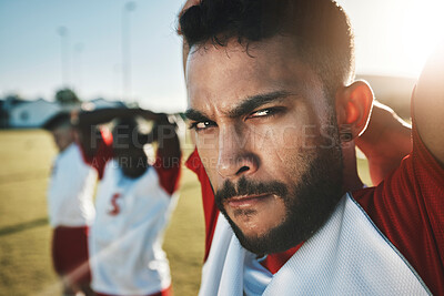 Buy stock photo Face, soccer and stretching with a sports man getting ready for a game on a grass pitch or field with his team. Fitness, football and exercise with a sport group getting ready for a workout or match