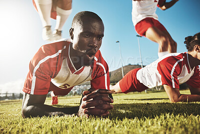 Buy stock photo Sports, soccer and football team doing push up before game, match or tournament for health, fitness and exercise for warm up. Black men, workout and training group on outdoor field for sport practice