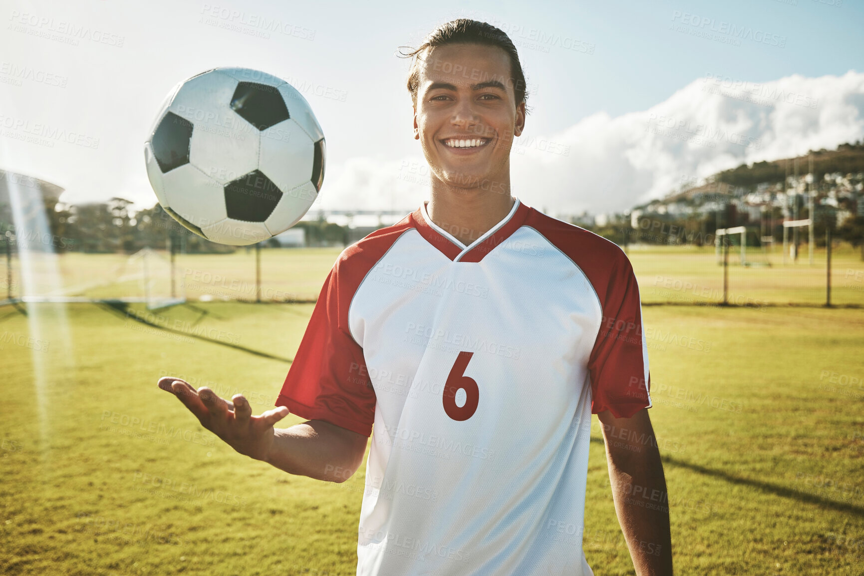 Buy stock photo Soccer, portrait and man on a field for training, sports or game in summer. Happy, excited and young athlete catching a football during exercise, fitness and cardio on a sport ground in a park