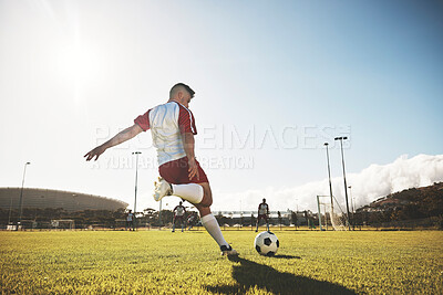 Buy stock photo Football, training and kick with man on field playing for sports, fitness and goals strike. Exercise, workout and soccer ball with athlete on grass for health, wellness and competition games