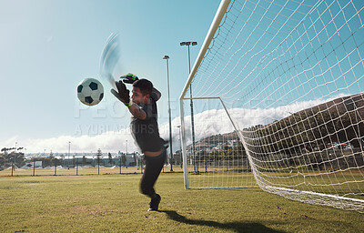 Goalkeeper, soccer and man jumping for the ball to save the goals by the score post at an outdoor field. Fitness, football and healthy male goalie playing or training with energy for the sports game.