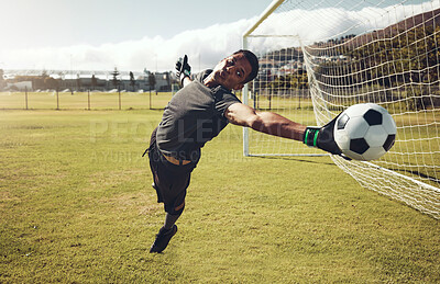 Buy stock photo Soccer, sports and goalkeeper training on a field for a professional competition. Young and strong athlete with energy and motivation catching a football during a game or exercise on a sport ground