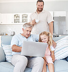 Family, laptop and girl relax with grandfather on sofa while father drinking coffee in the background, happy, cheerful and sweet. Love, happy family and online streaming by grandpa and child smiling