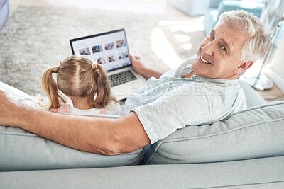 Buy stock photo Love, child and laptop on sofa with grandfather for screen app leisure together in Australia. Smile of happy and elderly grandpa streaming cartoon at family home to bond with grandchild.

