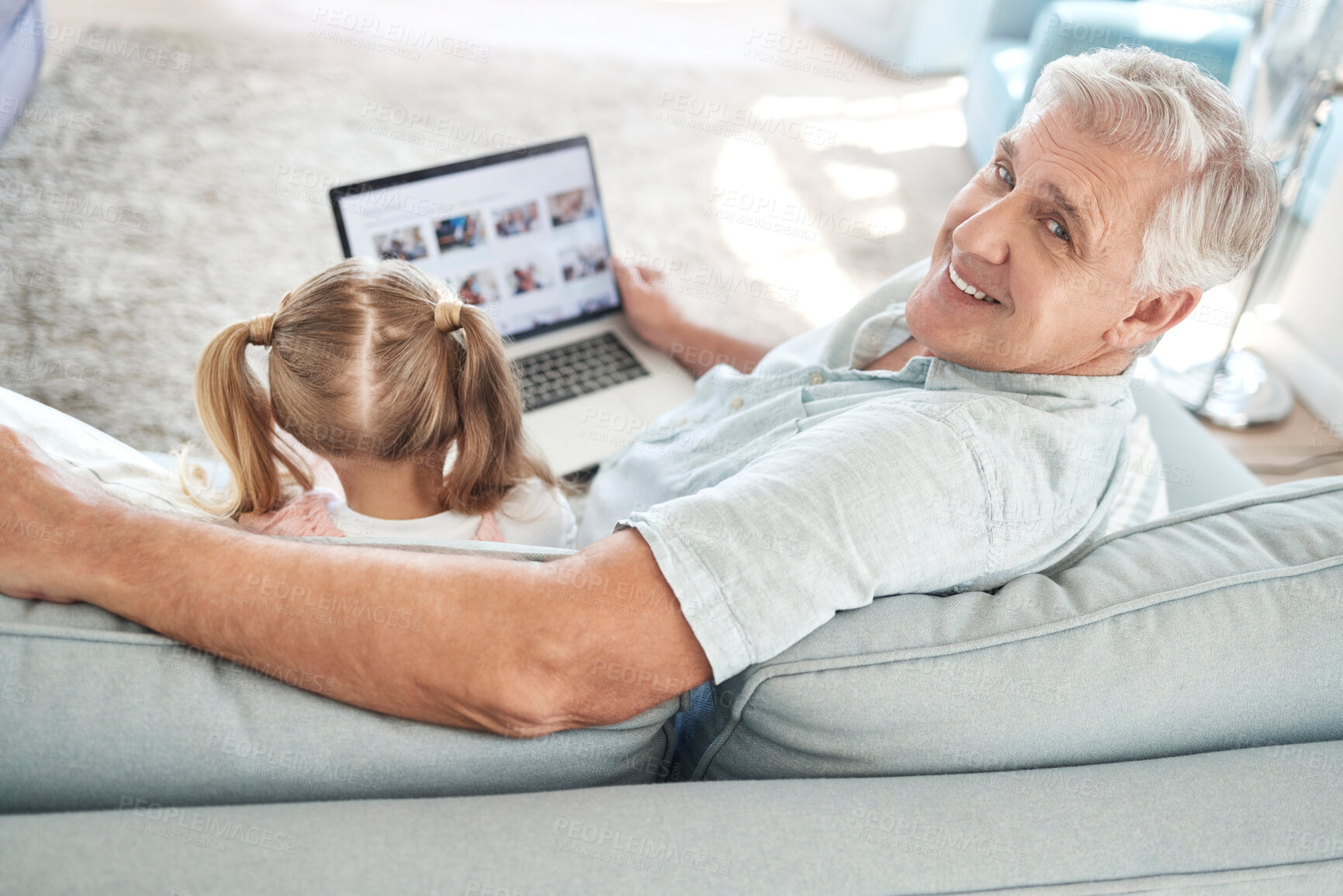 Buy stock photo Love, child and laptop on sofa with grandfather for screen app leisure together in Australia. Smile of happy and elderly grandpa streaming cartoon at family home to bond with grandchild.

