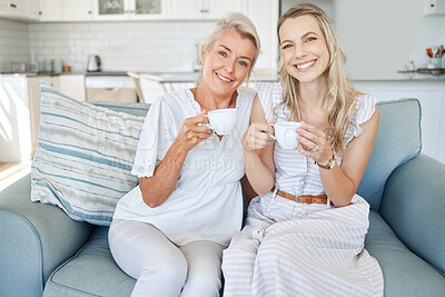 Buy stock photo Family, tea and love with a woman and senior mother sitting on the living room sofa together during a home visit. Coffee, happy and smile with a mature female and adult daughter bonding in a house