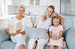 Laptop, phone or book with grandmother on sofa enjoying reading leisure with family in cozy home. Relax, family home and living room activity in Australia with happy grandma, mom and child.

