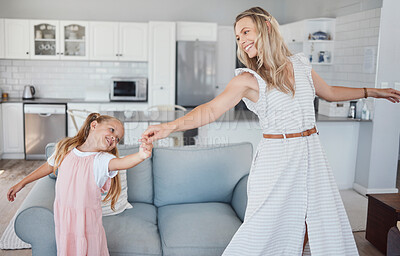 Buy stock photo Family, mother and girl child dancing for fun, energy and love in the living room feeling happy and holding hands to dance at home. Smile of woman and daughter moving to favorite song in USA house