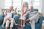 Happy grandparents, children and smile in relax for family bonding time together in the living room at home. Portrait of grandma, grandpa and little girls smiling in playful happiness for free time