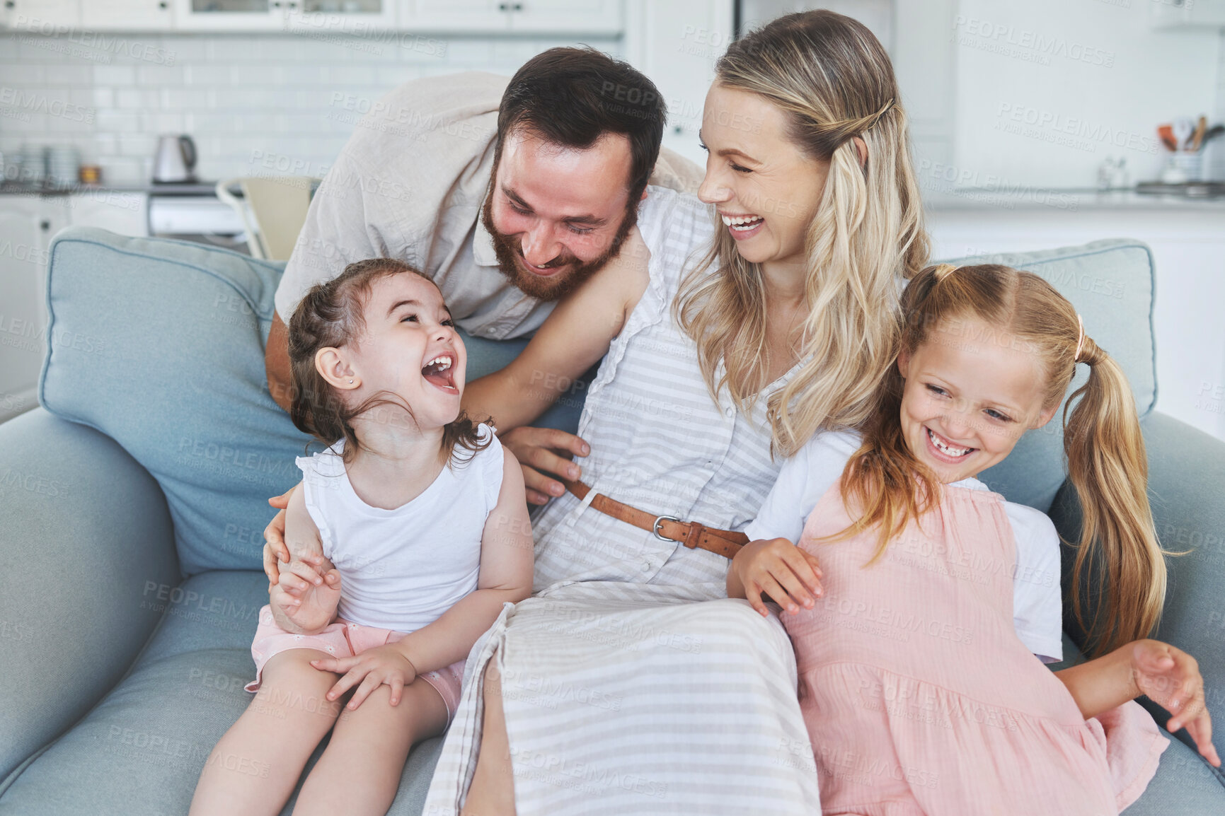 Buy stock photo Love, parents and happy family with children on sofa laughing for fun, bonding and leisure. Daughter, mom and dad with kids in Canada enjoy playful and excited smile together in living room.

