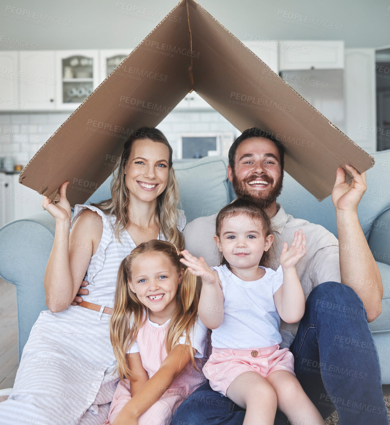 Buy stock photo Safety, happy and portrait of family with a roof or covering gesture with cardboard in the living room. Happiness, smile and home insurance of parents with girl children for protection in their house