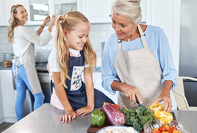 Buy stock photo Learning, mother and grandmother cooking with girl teaching her a family recipe, vegetables and food diet. Smile, mom and senior woman love helping kid in the kitchen with child development at home