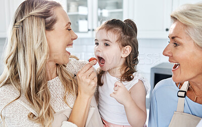 Buy stock photo Family, feeding and tomato with a girl and mother eating together in their home while grandmother comes to visit. Food, children and vegetables with a woman giving a daughter something healthy to eat