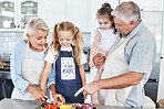 Cooking, smile and grandparents teaching children to cook food together in the kitchen of their house. Happy and young kids learning and helping an elderly man and woman with healthy lunch or dinner