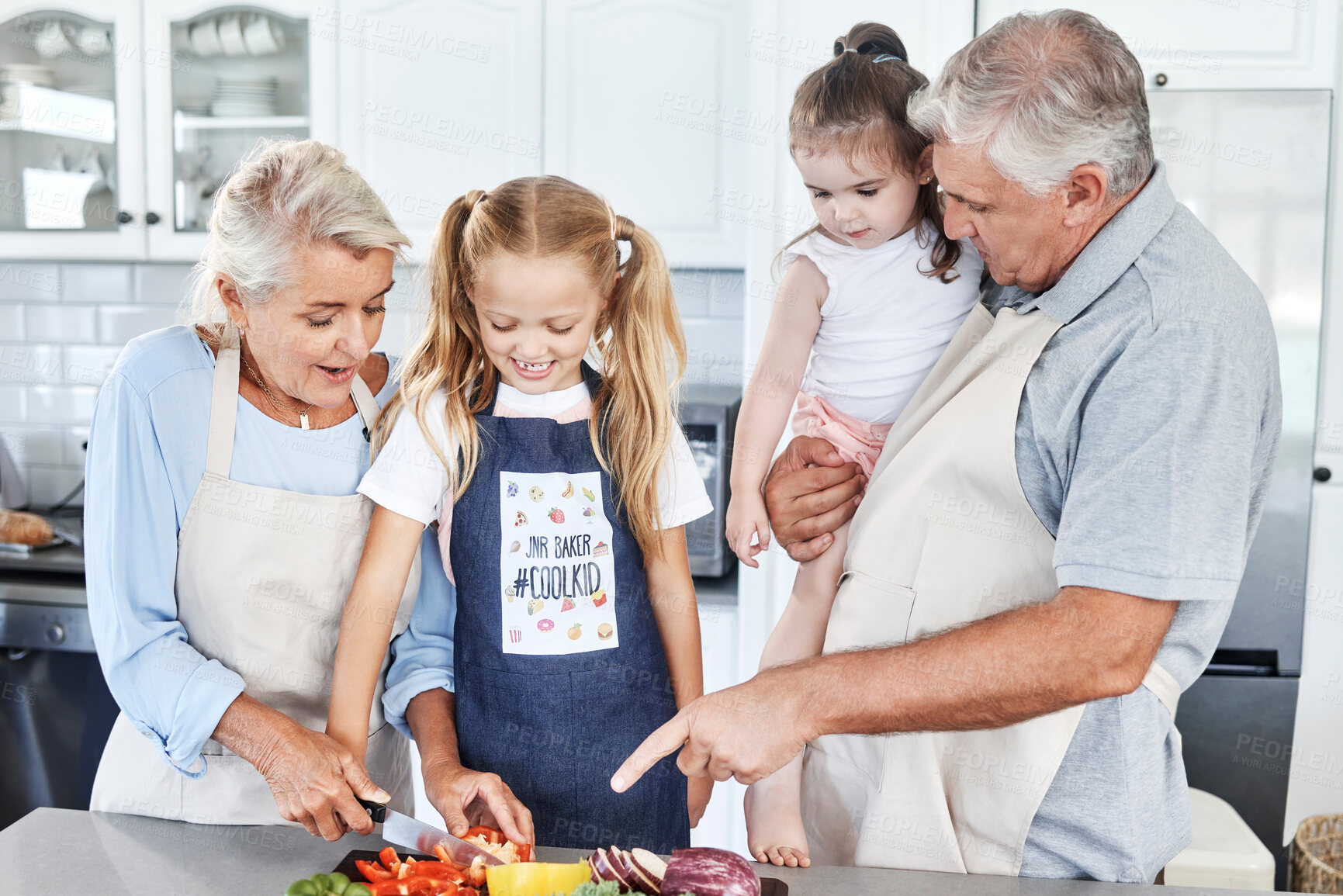Buy stock photo Cooking, smile and grandparents teaching children to cook food together in the kitchen of their house. Happy and young kids learning and helping an elderly man and woman with healthy lunch or dinner