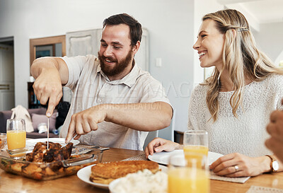 Buy stock photo Family, food and man cutting chicken at dinner party with woman smiling, eating and drinking together in dining room. Happy, care and celebrate, share time with couple and friends in home in Canada.