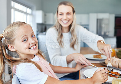 Buy stock photo Food, family and mother and daughter eating at a kitchen table, happy, relax and bonding in their home. Love, portrait and girl learning etiquette, nutrition and sharing meal with a cheerful parent 