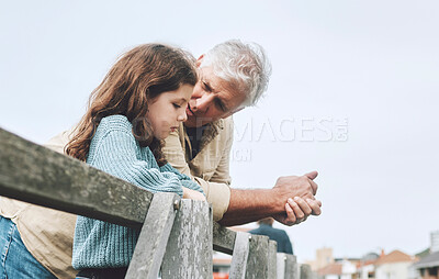 Buy stock photo Talking, children and love with a girl and grandfather bonding or spending time together outdoor on a pier. Conversation, care and relationship with a senior man and granddaughter chatting outside
