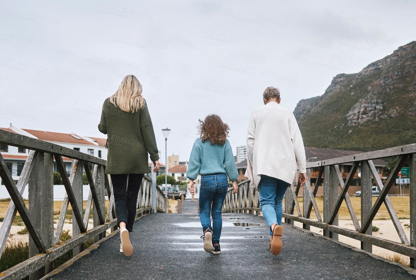 Buy stock photo Family, walking and bridge in nature by mountain together on holiday, vacation and relax. Group, people and walk for bonding, time and love with kid, mother and grandmother on travel to Norway