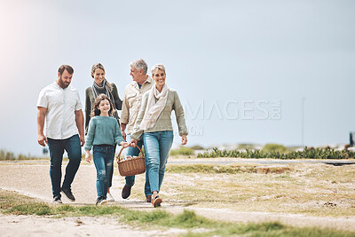 Buy stock photo Big family, happy and walking for a picnic on holiday, vacation or weekend trip outdoors for relaxing and bonding. Mother, father and grandma travel with old man and girl child to enjoy quality time