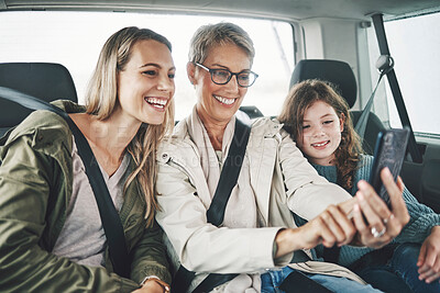 Buy stock photo Phone, selfie and happy family in a car for a road trip driving or traveling to a holiday vacation adventure together. Grandma, mother and excited girl or child enjoy pictures for a fun weekend 