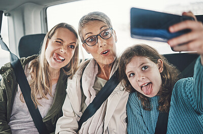 Buy stock photo Phone, selfie and family in a car with silly faces driving to a holiday destination together. Grandmother, mother and girl child taking picture on smartphone on the route to vacation resort in Canada