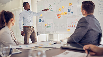 Buy stock photo Businessman, leader or ceo with presentation on a whiteboard for marketing team during a meeting in an office boardroom. Black man or manager with research graphs and advertising data while planning