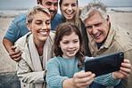 Family, girl and phone selfie on beach holiday adventure spending time with parents and grandparents. Men, women and child smile in Australia, happy fun on winter hike by sea and photo on smartphone