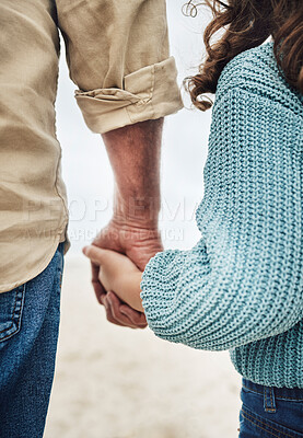Buy stock photo Hands, family and children with a girl and grandfather holding hands while walking outside on the beach. Kids, love and trust with a senior man and granddaughter hand in hand on a walk outdoor