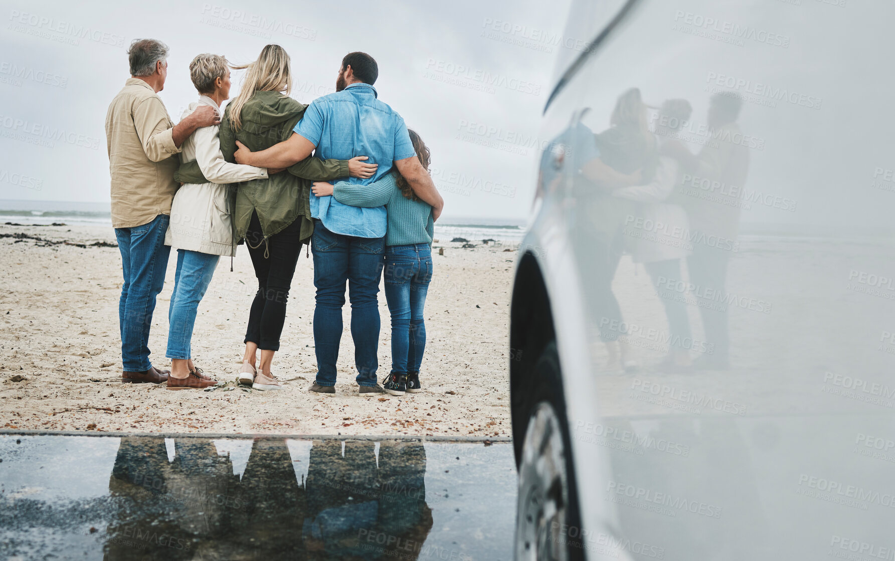 Buy stock photo Travel, love and big family hug at ocean for bonding experience on road trip in Australia. Adventure, beach and drive for holiday break sightseeing with parents, grandparents and child.

