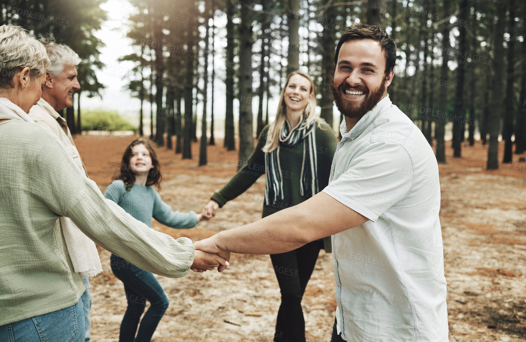 Buy stock photo Happy family, hands and dance in forest with girl, parents and grandparents dancing in a circle in nature. Family, kids and holding hands with cheerful excited and laughing people in a park together